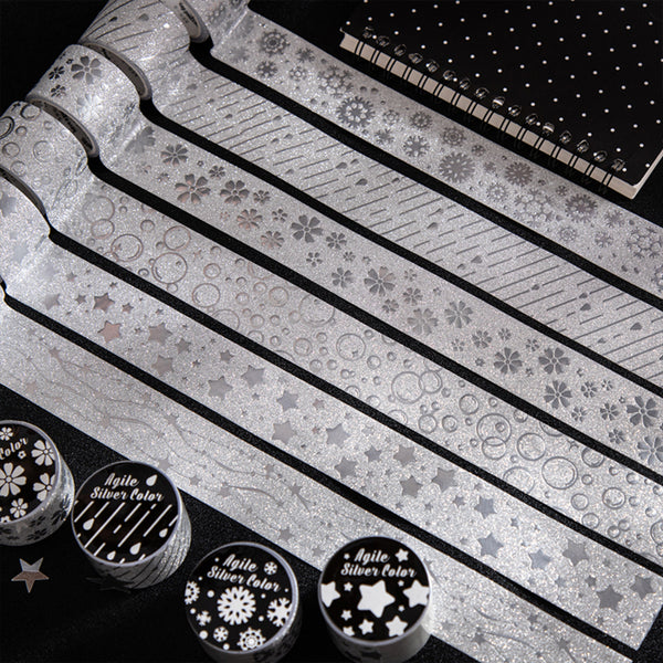 Decorative paper strips with patterns and a set of stamps on a black background