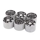 Set of six cylindrical containers with black lids featuring white designs on a white background