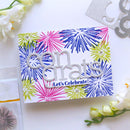 A handmade congratulations card featuring a white background decorated with colorful firework patterns in blue, pink, and lime green. The card is adorned with a glittery silver die-cut 'Congrats' word art and a smaller banner reading 'Let's Celebrate!'.