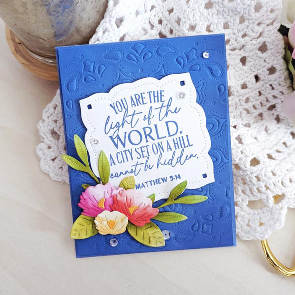 Blue card with floral design and Bible verse on a white lace background