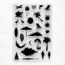 A sheet of clear acrylic or rubber stamps featuring black tropical and beach-themed silhouette designs, including palm trees, a sun, surfboard, hammock, lounge chair, flamingos, crescent moon, and island shapes, shown on a white background.