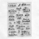 A sheet of clear acrylic or plastic stamps with black printed phrases and small decorative motifs, photographed on a plain white background.