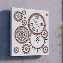 A square white wall clock with laser-cut geometric gear and clock-face designs, mounted on a textured gray wall.