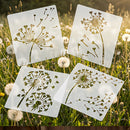 Four square white stencil sheets with dandelion cutouts arranged on a grassy field with dandelions in the background.