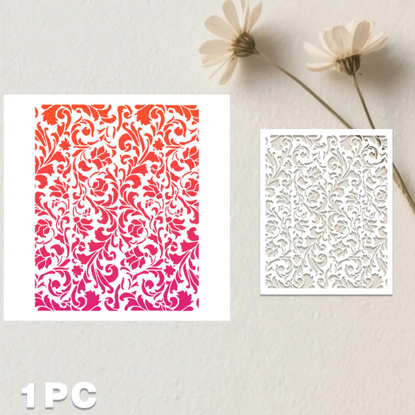 Two square laser-cut paper designs displayed on a light textured background with dried flowers. The left sheet shows a repeating floral damask pattern in a red-to-pink gradient, and the right sheet shows a white floral cutout pattern.