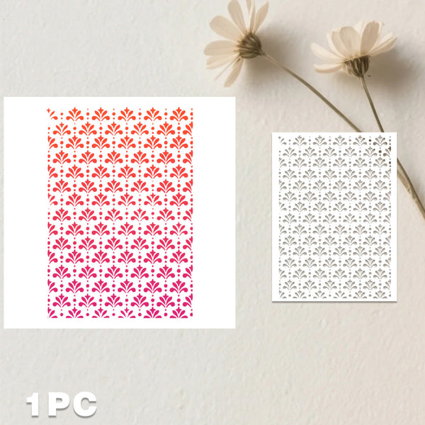 Two rectangular white sheets with repeating floral cutout or printed patterns, displayed on a light textured wall with dried flowers above. One sheet shows a red-to-pink gradient pattern, and the other shows a darker gray floral pattern.