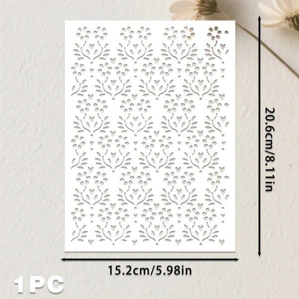 A white rectangular sheet with an allover laser-cut floral and leaf pattern, shown with dimension arrows indicating 15.2 cm by 20.