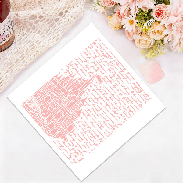 A square white art print featuring a pink architectural illustration surrounded by script, styled flat-lay on a white surface with a lace cloth, flowers, and a small pink petal.