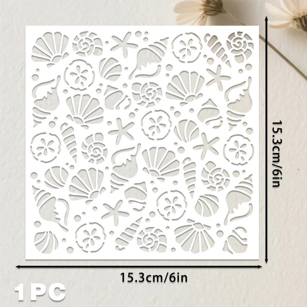 A square white laser-cut stencil or craft sheet with an all-over seashell and starfish pattern, shown on a light neutral background with dimension labels reading 15.3cm/6in on both width and height.