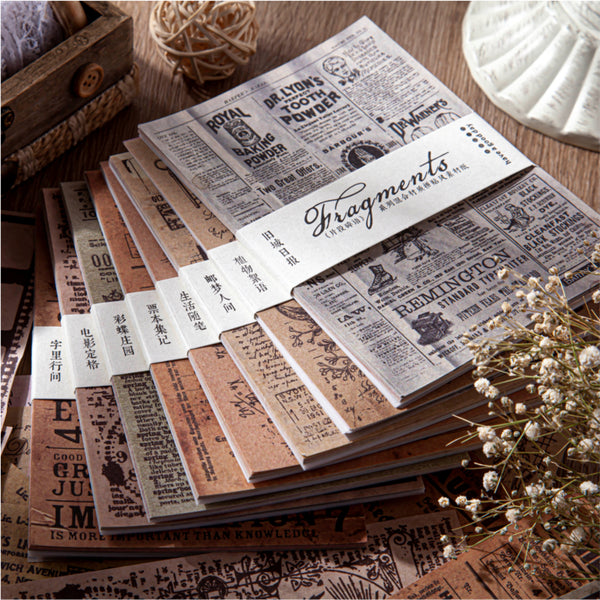 Stack of vintage-style notebooks with text and design on a wooden surface.