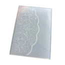 A rectangular translucent plastic mold or stamp with an etched floral rose pattern and scalloped border, shown on a plain white background.