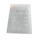 A translucent clear acrylic stamp or embosser featuring a floral border design with roses and a bow around a blank rectangular center, shown on a plain white background.
