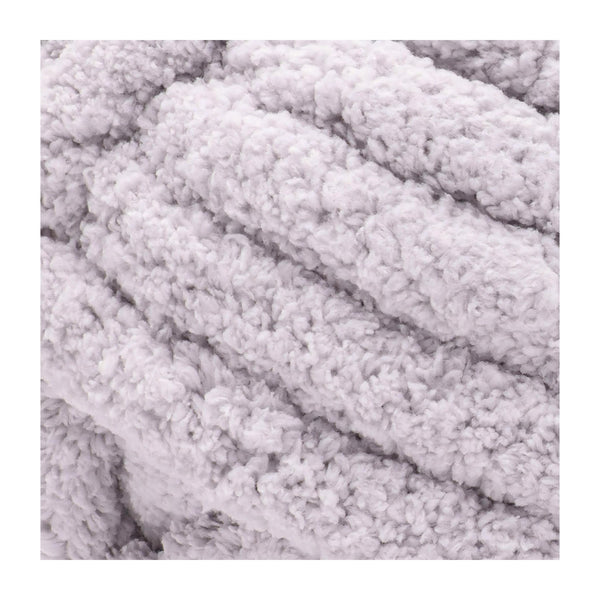 A close-up of a light lavender-gray plush chenille fabric texture with soft, looped fibers.