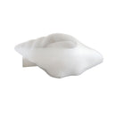 A white, organic-shaped silicone mold or mold insert with a central cavity, shown on a solid white background.
