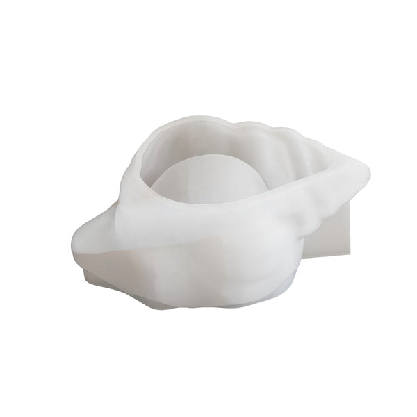 A white silicone mold designed for making soap, shaped like a clam shell with a smooth, rounded interior cavity, shown on a plain white background.