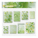 A sheet of decorative stickers or transfer designs featuring green floral and butterfly motifs on a white textured background, with a header reading 'Moss Green Butterfly.' The designs include translucent green butterfly and flower patterns, embossed-style floral panels, and several pale green and yellow botanical prints.