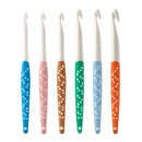 Set of six colorful crochet hooks with patterned handles on a white background