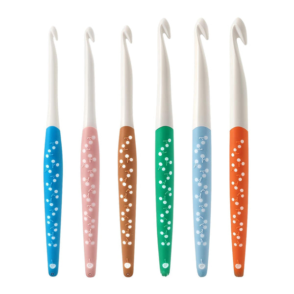 Set of six colorful crochet hooks with patterned handles on a white background