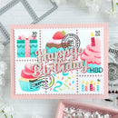 Decorative birthday card with stamps featuring birthday-themed designs on a white background.