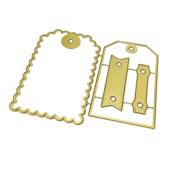 Gold metal embossing dies shown on a plain white background, including one scalloped tag-shaped die and one rectangular die with two ribbon-cut style sections.