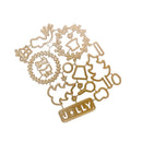 A gold-colored metal die-cut craft sheet featuring Christmas-themed shapes including a wreath, reindeer, bell, tree, ornaments, and a banner reading 'JOLLY'.