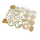 A set of gold-colored metal fruit and vegetable cutters or stamps arranged on a plain white background, including designs like a pineapple, strawberry, cherry, watermelon slice, citrus, and leaf motifs.
