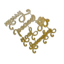 Gold-colored metal script lettering pieces spelling out 'Merry Peace Joy December' arranged on a plain white background.
