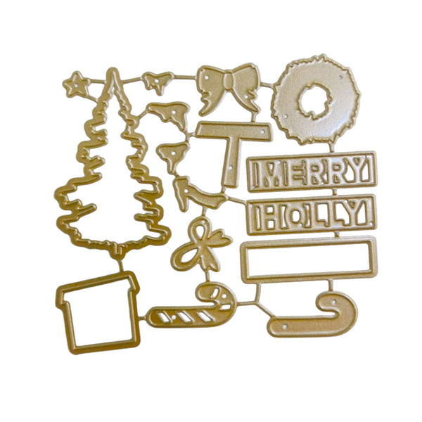 A set of gold-colored metal holiday crafting dies arranged on a plain white background, featuring shapes like a Christmas tree, wreath, bows, candy cane, jingle bells, and 'MERRY HOBBY' text blocks.