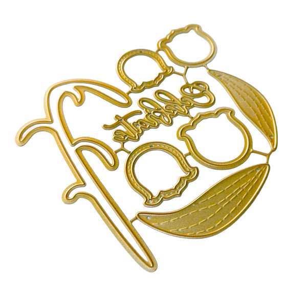 A gold metal die-cut craft embellishment featuring a stylized floral and script design on a plain white background.