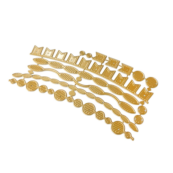 A set of gold-colored metal craft dies with various geometric and organic shapes, arranged diagonally on a plain white background.