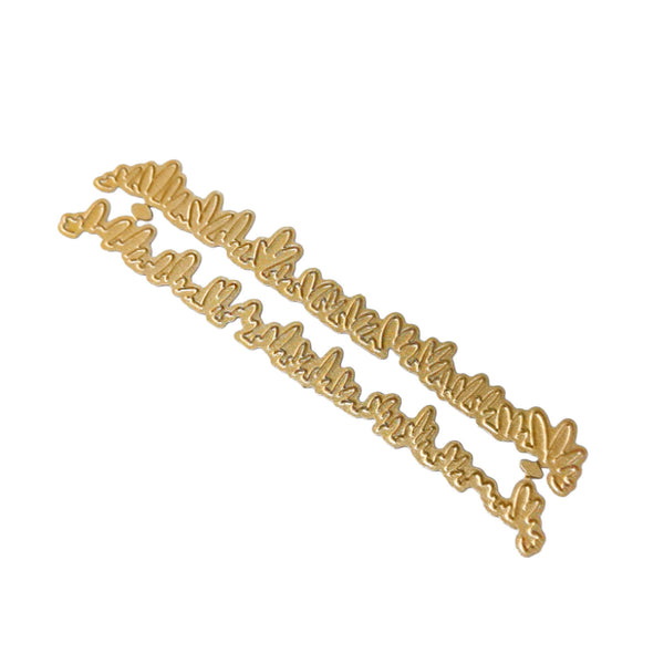 A gold-colored metal script nameplate or sign with cursive lettering, shown on a plain white background.