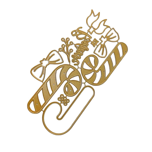 A gold-colored metal die-cut craft embellishment featuring holiday motifs including candy canes, bows, a snowman, and the word 'Merry' on a plain white background.