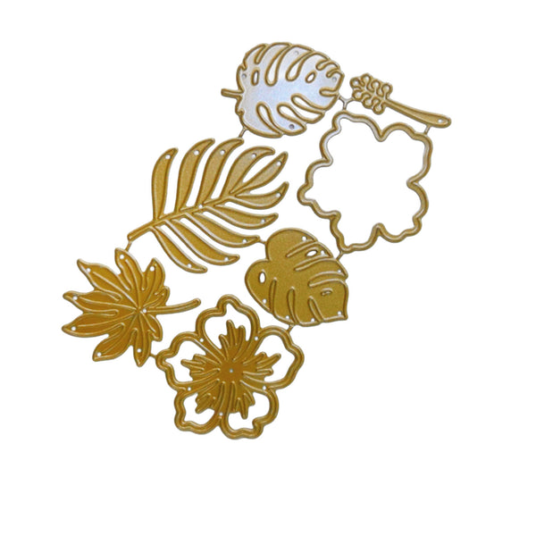 A set of gold metal die-cut embellishments featuring tropical leaves (monstera, palm, philodendron) and a hibiscus flower, alongside a scalloped oval outline, shown on a plain white background.
