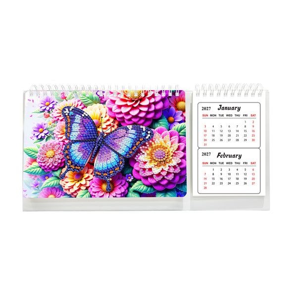 A spiral-bound desk calendar with a colorful floral and butterfly design on the cover, shown open to display the January and February 2027 pages on a white background.