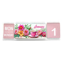 A pink spiral-bound desk calendar showing January 1st, with a floral front cover and pink pages indicating Monday and the number 1.