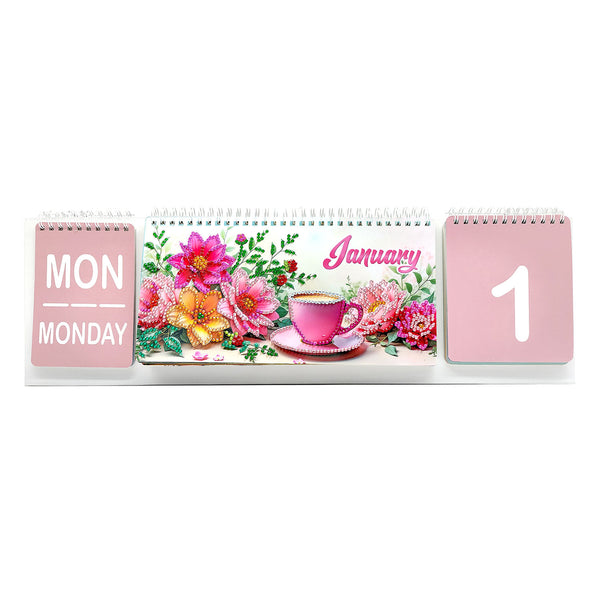 A pink spiral-bound desk calendar showing January 1st, with a floral front cover and pink pages indicating Monday and the number 1.