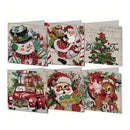 Six Christmas-themed diamond painting cards arranged in two rows on a plain white background. The designs include a snowman with a top hat, Santa Claus, a Christmas tree, a red car with gifts, Santa Claus with presents, and a deer with a stocking.