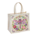 A clear plastic tote bag with beige handles, featuring a colorful embroidered dragonfly and floral design on the front, set against a plain white background.