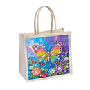 A cream-colored canvas tote bag with a clear vinyl front cover featuring a colorful diamond painting design of a butterfly and flowers, set against a plain white background.