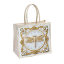 A clear plastic tote bag with cream-colored handles, featuring a decorative front panel with a gold dragonfly embellished with rhinestones, surrounded by a white lace pattern and small white flowers.