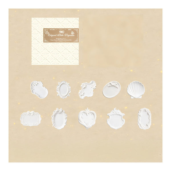 A beige card or packaging insert showing a set of white embossed or raised decorative frame shapes, including oval, scalloped, and shell-like motifs. A small cream textured label with a brown brand plaque appears in the upper left.