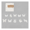 A sheet of white butterfly and floral die-cut stickers displayed on a textured gray background, with the brand label 'Mia's Butterflies' visible in the upper left.