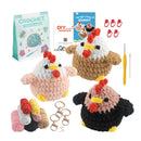 Crocheted chicken toys with crochet supplies on a white background