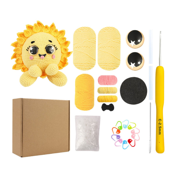 Crochet kit with a sun-shaped plush toy, yarn, needles, and other tools on a white background