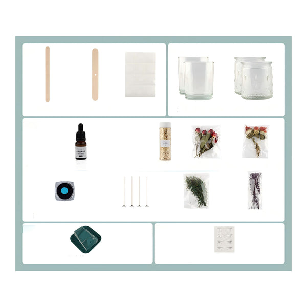 A product kit arranged in a grid on a white background with a pale blue border. The kit includes two wooden spatulas, white cotton pads, two clear glass jars, a small amber dropper bottle, a jar of dried botanicals, two small flower bouquets in packets, a round blue-and-black item, four metal pins, dried green and purple botanical pieces, a dark green square item, and a sheet of white labels.