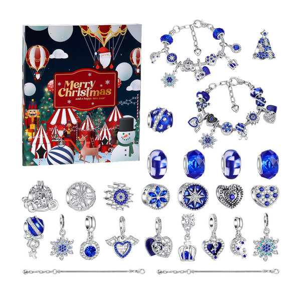 A Christmas-themed jewelry set displayed on a white background, featuring a colorful Christmas-themed gift box, multiple silver charm bracelets, several blue and silver beads, and several silver pendants with blue accents. The box has a festive holiday illustration with the text 'Merry Christmas'.