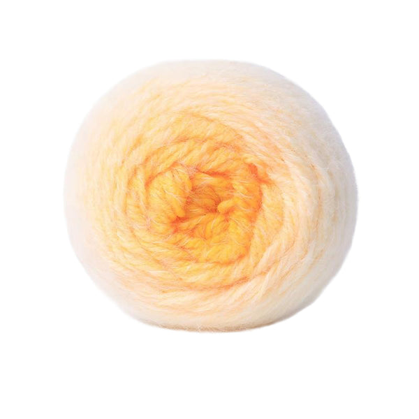 A single ball of soft, fuzzy yarn in a pale peachy yellow color, photographed against a solid white background.