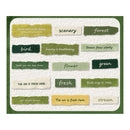 A square wall art print featuring a collage of textured paper strips in muted green, olive, and cream tones with hand-written nature-themed phrases such as 'forest,' 'bird,' 'flower,' 'stream,' and 'the air is fresh here.'.