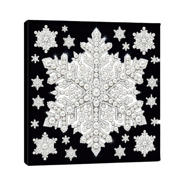 A square black canvas wall art print featuring a large ornate snowflake design in white and silver tones, surrounded by smaller matching snowflakes, shown at a slight angle on a white background.