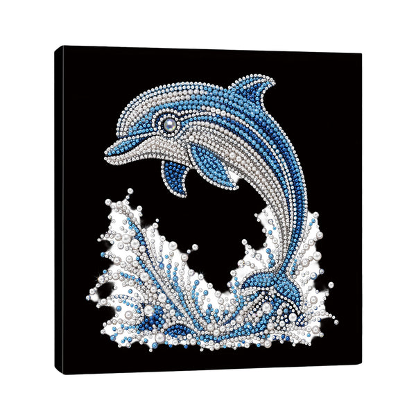 A square black canvas wall art piece featuring a stylized dolphin jumping above white and blue splashing waves, made with rhinestone-like dots. The canvas is shown at a slight angle against a plain white background.
